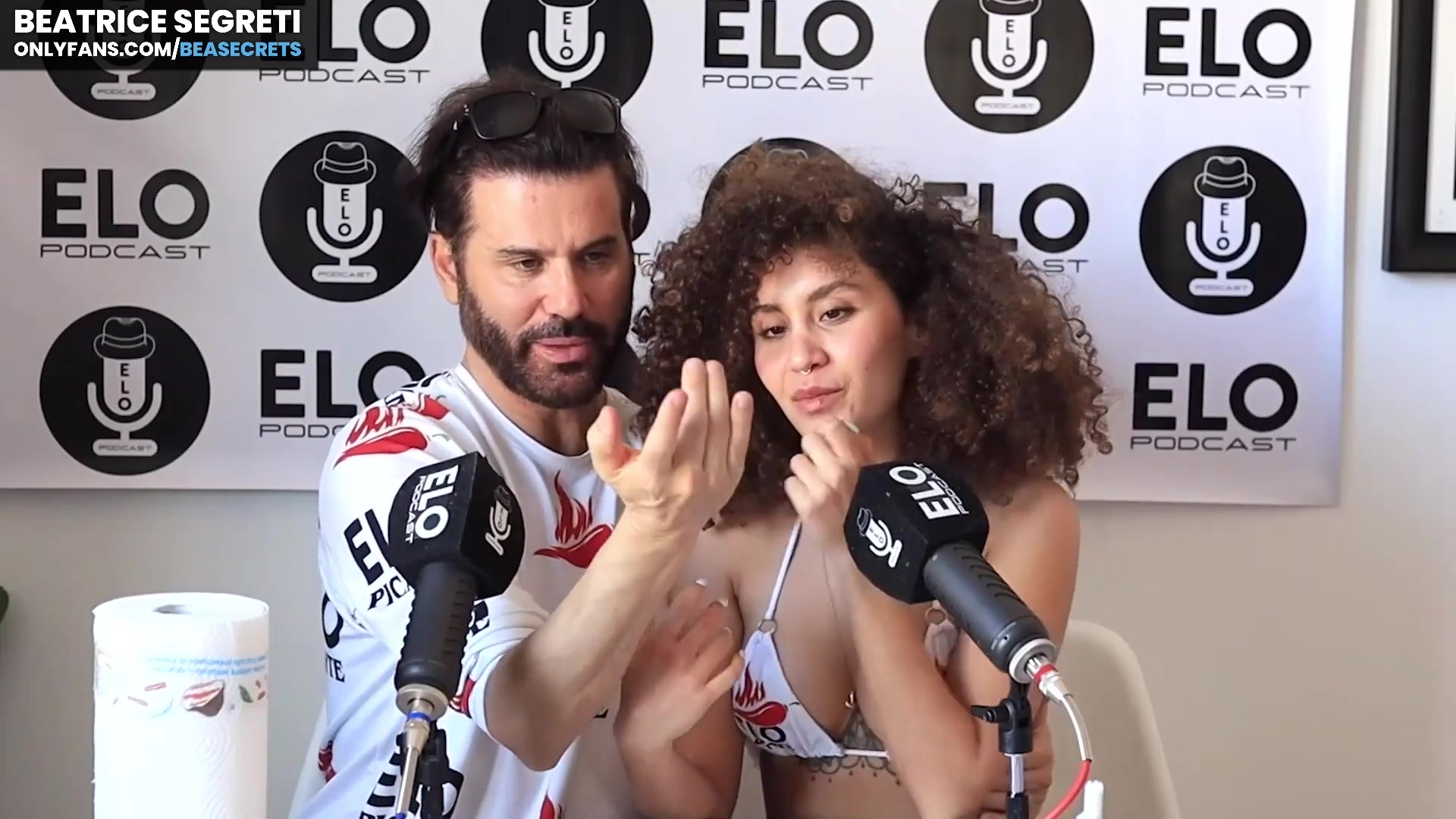 A woman on her knees offering a passionate embrace to a man