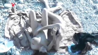 Beach Voyeur. Hot babe with big natural tits gives head on a public beach