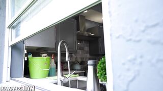 A fiery-haired woman possessing exceptionally full breasts and a considerable rear.