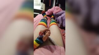 Weak femboy in pink schoolgirl uniform and rainbow gloves & stockings cums